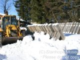 Image shows a backhoe helping to install the new log chute. 