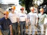 Image shows members of the construction team posing for a photo. 