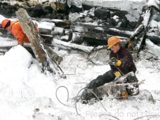 Image shows men in hardhats working in the snow. 