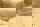 Image shows a faded photo of a person standing beside a lake. 