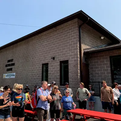 Image shows a crowd of people outside the Dorset Recreation Centre.