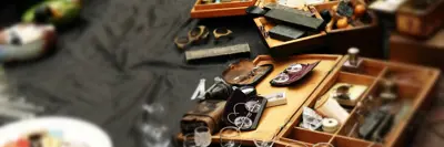 Image shows random objects on a table during a yard sale. 