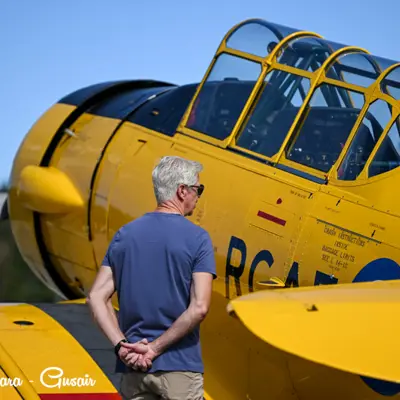 Image shows a man looking at an airplane. 