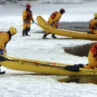 Image shows firefighters conducting ice water training. 