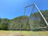 Image shows the backstop of a baseball diamond. 