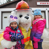 Image shows two children with the Sparky mascot. 