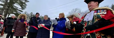 Image shows the mayor and other dignitaries cutting the ceremonial ribbon at the Dorset Snow Ball Winter Carnival.