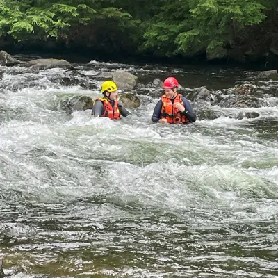 Image shows firefighters conducting swift-water training. 