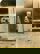 Image shows a black and white photo of a child in the corner of a doorway. 
