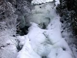 Image shows the Hawk Lake Log Chute covered in snow and ice. 