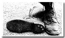 Image shows a weathered pair of boots.