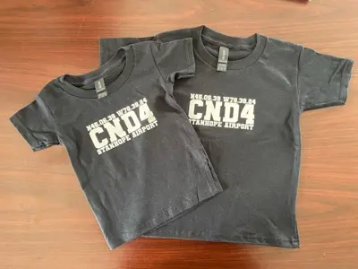 Image shows black T-shirts.