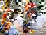 Image shows men in hardhats working. 