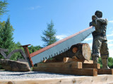Image shows statue of a lumberjack. 
