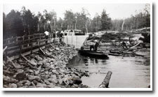 Image shows loggers near a dam.