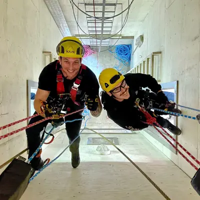 Image shows firefighters training on ropes. 